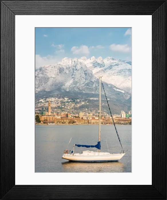Framed Print : Close up of a boat on Lecco lake with Lecco city and Resegone mount in the background