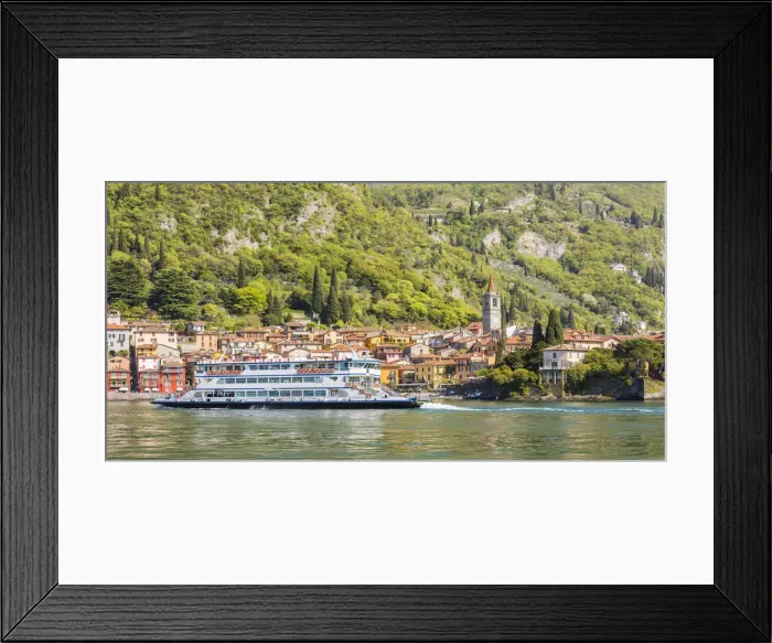 Framed Print : A touristic ferry crossing Lake Como with the village of Varenna in the background Framed Print : A touristic ferry crossing Lake Como with the village of Varenna in the background