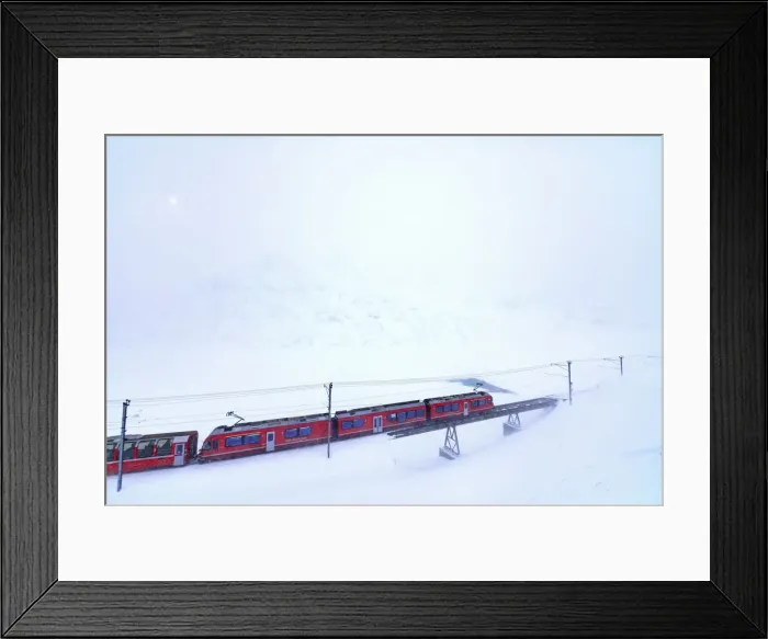 Framed Print : Bernina Express train at Bernina Pass during a snowstorm, canton of GraubAonden, Engadin