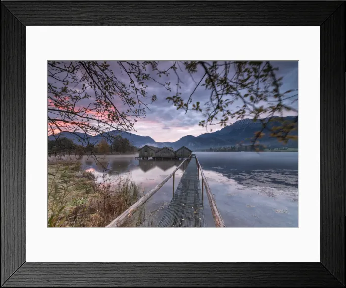 Framed Print : Purple sky at sunset and wooden huts are reflected in the clear water of Kochelsee Framed Print : Purple sky at sunset and wooden huts are reflected in the clear water of Kochelsee