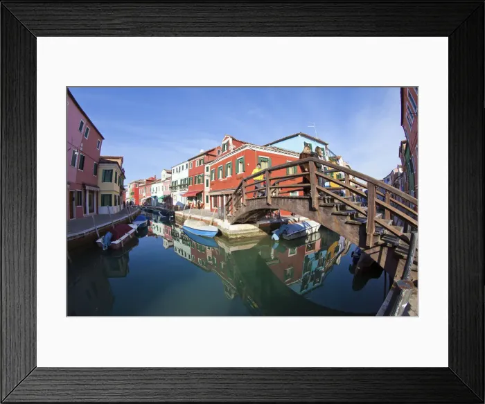 Framed Print : The many colours of the typical houses of Burano are reflected into the green waters Framed Print : The many colours of the typical houses of Burano are reflected into the green waters