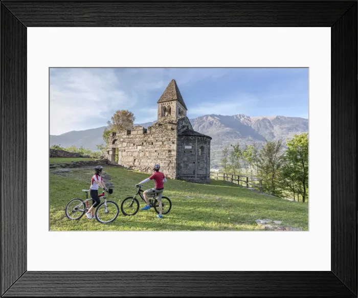 Framed Print : Cyclists admire the ancient Abbey of San Pietro in Vallate in spring Piagno Sondrio Framed Print : Cyclists admire the ancient Abbey of San Pietro in Vallate in spring Piagno Sondrio