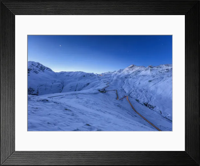 Framed Print : Blue light of dusk on the snowy landscape and the hairpin turns of Stelvio Pass Braulio Framed Print : Blue light of dusk on the snowy landscape and the hairpin turns of Stelvio Pass Braulio