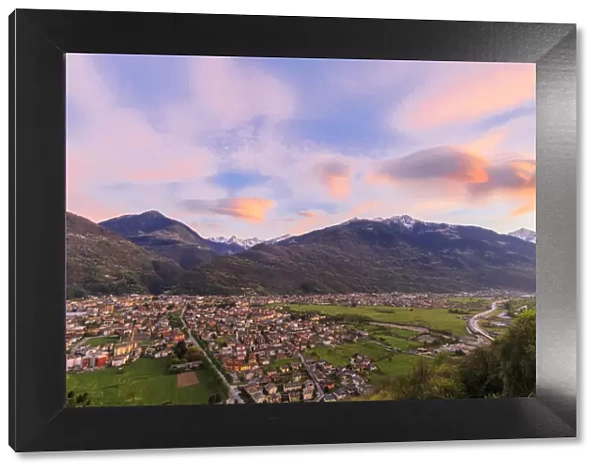 The pink sky at sunset frames the town of Morbegno province of Sondrio Lombardy Valtellina