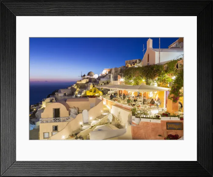 Framed Print : Dining experience at dusk in Oia, Santorini, Cyclades Islands, Greece