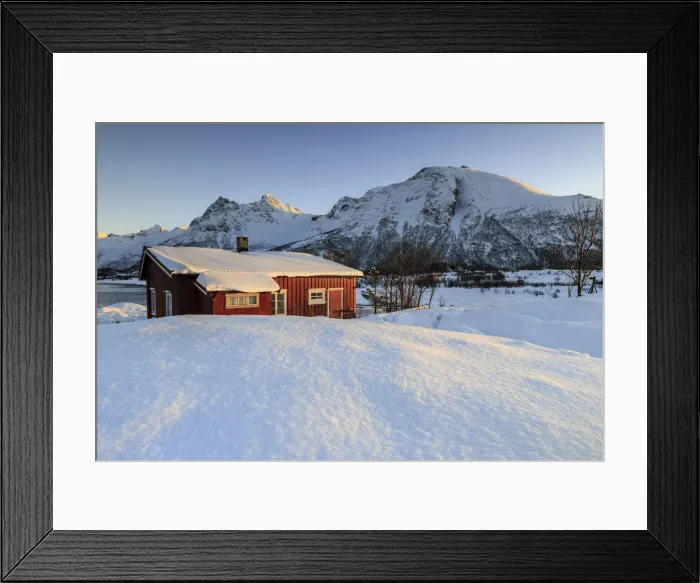 Framed Print : The winter sun illuminates a typical Norwegian red house surrounded by fresh snow
