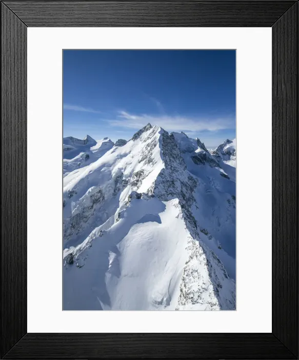 Framed Print : Aerial view of the long crest of ice and rock that takes to Bernina peak. Engadine Framed Print : Aerial view of the long crest of ice and rock that takes to Bernina peak. Engadine