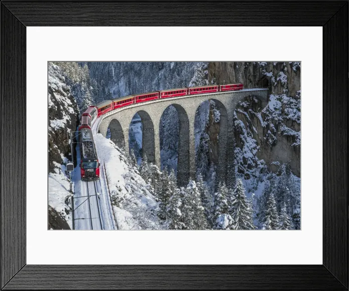 Framed Print : Red train going on the Landwasser Viadukt in winter. Filisur, Canton of graubunden Framed Print : Red train going on the Landwasser Viadukt in winter. Filisur, Canton of graubunden