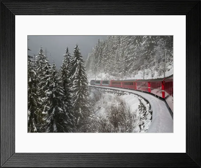 Framed Print : Red train travelling through the snowy woods of Filisur on the highest railway across Framed Print : Red train travelling through the snowy woods of Filisur on the highest railway across