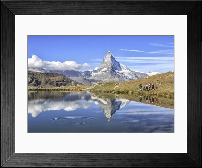 Framed Print : Hikers walking on the path beside the Stellisee with the Matterhorn reflected Framed Print : Hikers walking on the path beside the Stellisee with the Matterhorn reflected