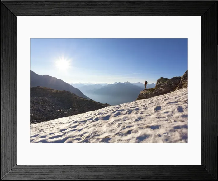 Framed Print : A hiker on the snowfield under the summit of Peterskopfl, Zillertal Alps