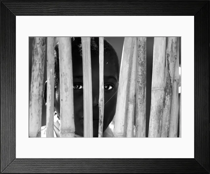 Framed Print : Portrait of a boy behind the fence. Malawi, Africa Framed Print : Portrait of a boy behind the fence. Malawi, Africa