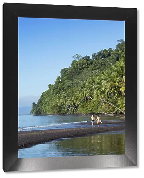 Central America, Costa Rica, Golfito, a young couple on a black sand beach in Piedras