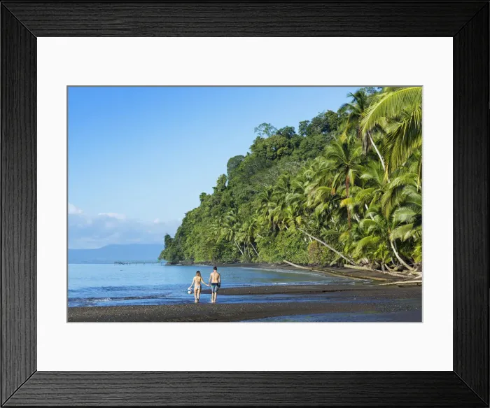 Framed Print : Central America, Costa Rica, Golfito, a young couple on a black sand beach in Piedras Framed Print : Central America, Costa Rica, Golfito, a young couple on a black sand beach in Piedras