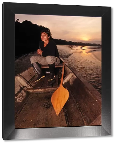 Man in dugout canoe on the Lago de Tarapoto, Amazon River, near Puerto Narino, Colombia