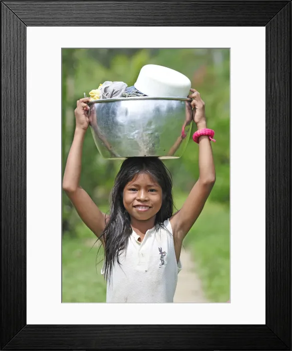 Framed Print : Young girl with a bucket on her head, Amacayon Indian Village, Amazon river, Puerto