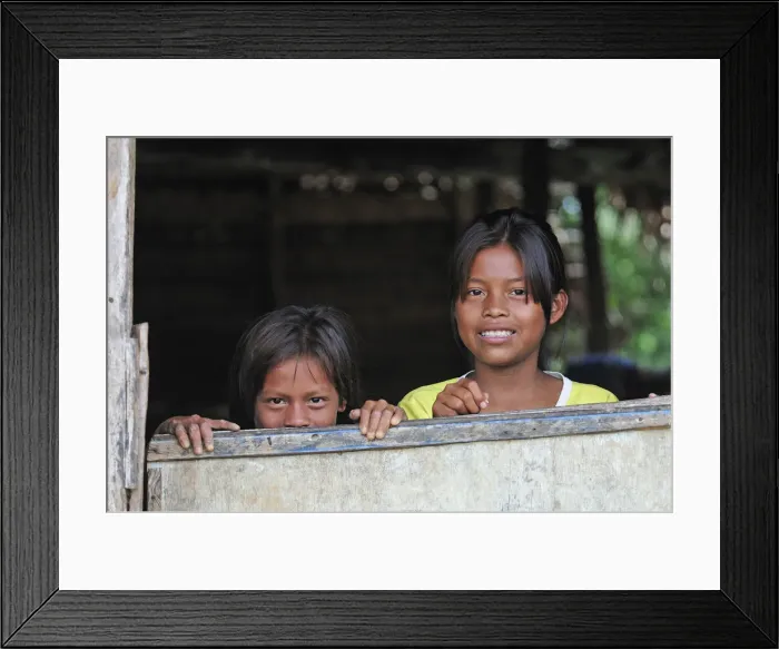Framed Print : Two young girls looking out of a window, Amacayon Indian Village, Amazon river, Puerto