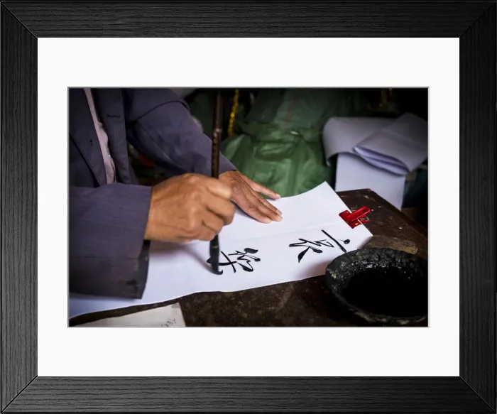 Framed Print : Man is writing with chinese idioms at Shigu Village or Stone Drum Village, Lijiang Framed Print : Man is writing with chinese idioms at Shigu Village or Stone Drum Village, Lijiang
