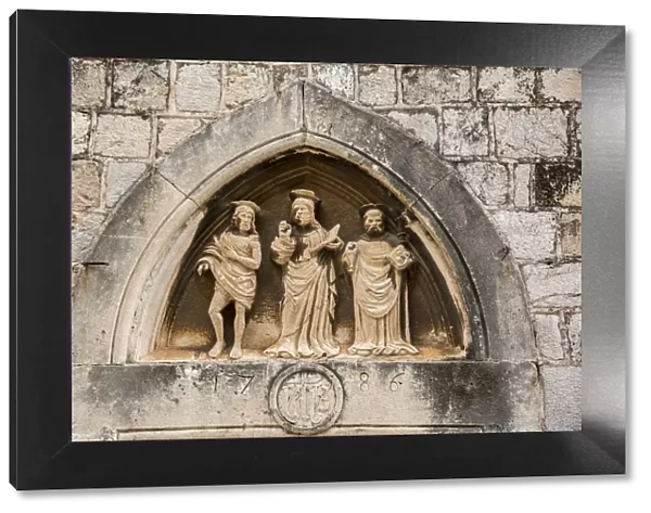The three saints statues carved above the entrance door of Church of St Luke, Dubrovnik