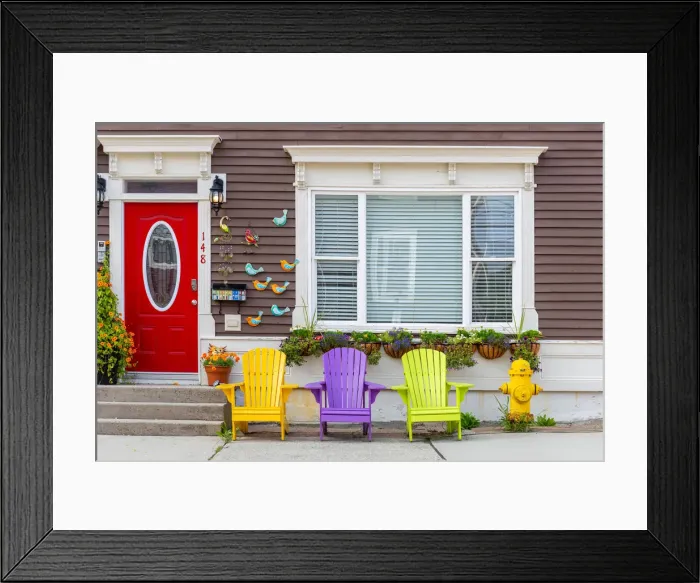 Framed Print : Wooden colorful dechchairs in front of traditional house in St Johns downtown Framed Print : Wooden colorful dechchairs in front of traditional house in St Johns downtown