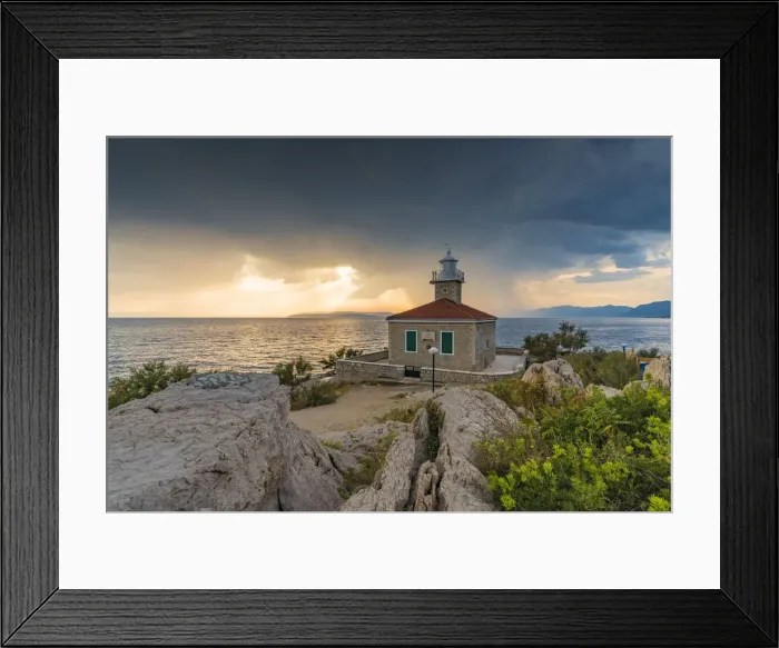 Framed Print : The sun is setting down behind St Peter lighthouse, in summer Framed Print : The sun is setting down behind St Peter lighthouse, in summer
