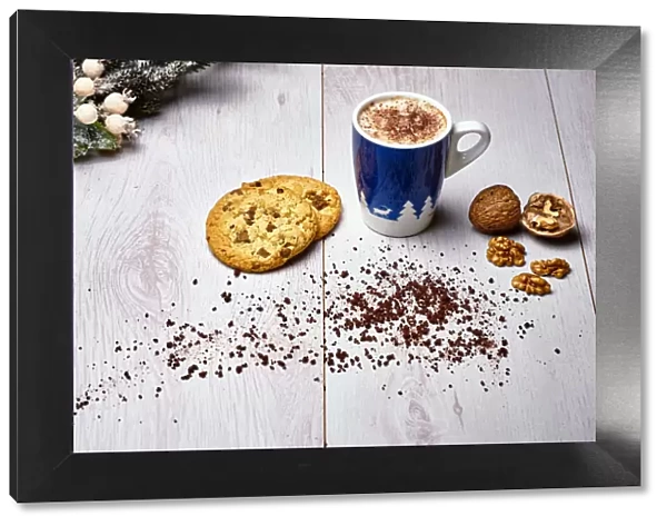 Italian cappuccino with cookies and walnuts on a white wooden table