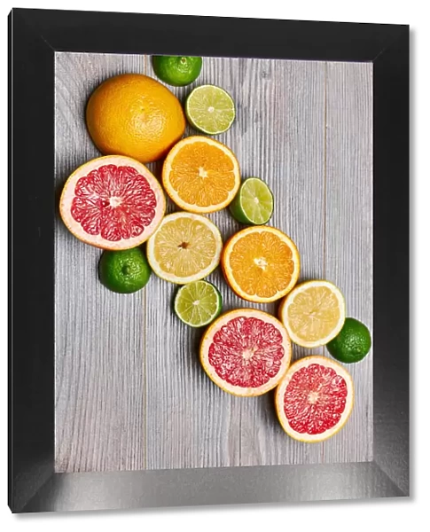 Top view of citrus fruits on white wooden table