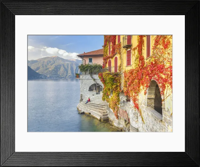 Framed Print : A man sitting on the steps of Nesso village admire the lake of Como, Como province Framed Print : A man sitting on the steps of Nesso village admire the lake of Como, Como province
