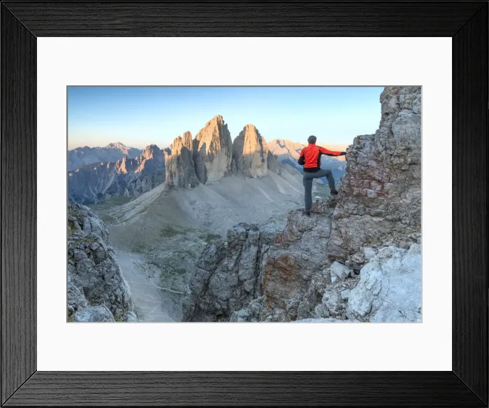 Framed Print : Hiker on the top of mount Paterno  /  Paternkofel looking the sunrise towards Tre Cime