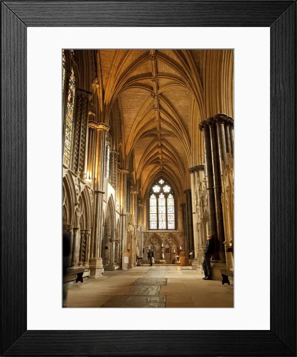 Framed Print : Lincoln, England. A visitor gazes at the medieval stone work in Lincoln cathedral
