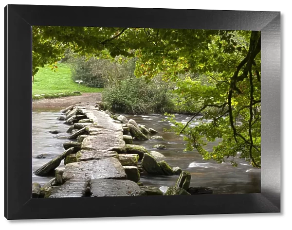 Ancient Tarr Steps clapper bridge crossing the River Barle in Exmoor National Park