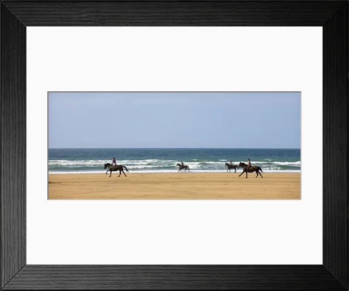 Framed Print : Horse riders galloping down sandy Cornish beach on a summers day, Sandymouth Framed Print : Horse riders galloping down sandy Cornish beach on a summers day, Sandymouth