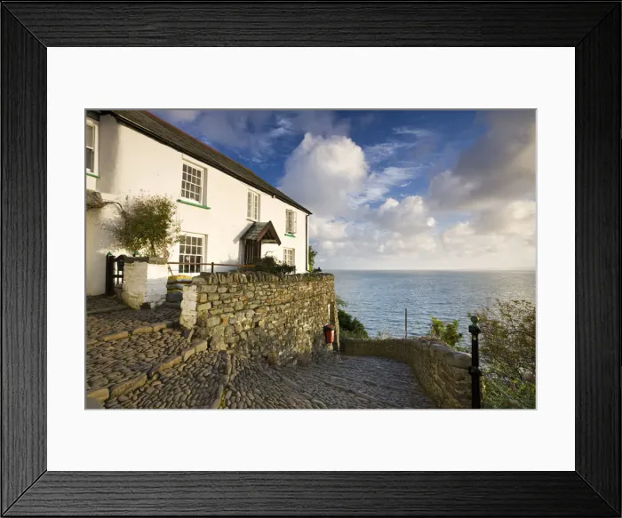 Framed Print : Whitewashed cottage and cobbled lane in the picturesque village of Clovelly, Devon Framed Print : Whitewashed cottage and cobbled lane in the picturesque village of Clovelly, Devon