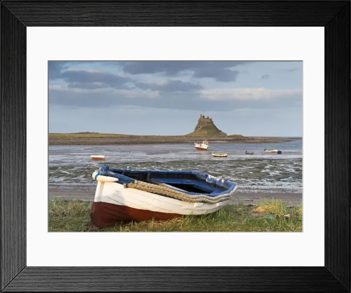 Framed Print : Fishing boat pulled onto the shore at Holy Island, looking towards the castle, Lindisfarne Framed Print : Fishing boat pulled onto the shore at Holy Island, looking towards the castle, Lindisfarne