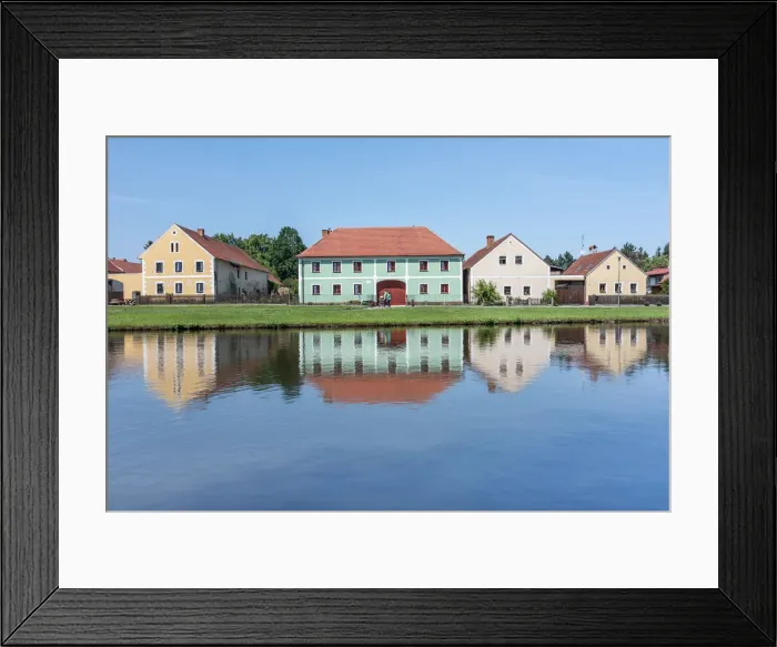 Framed Print : Houses in the historical village of Holasovice reflected in the Roubaicek pond Framed Print : Houses in the historical village of Holasovice reflected in the Roubaicek pond