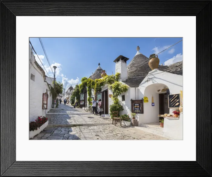 Framed Print : View of the typical Trulli huts and the alleys of the old village of Alberobello Framed Print : View of the typical Trulli huts and the alleys of the old village of Alberobello