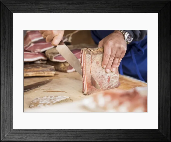 Framed Print : a butcher is cutting a piece of Speck, the typical kind of prosciutto, bolzano Framed Print : a butcher is cutting a piece of Speck, the typical kind of prosciutto, bolzano