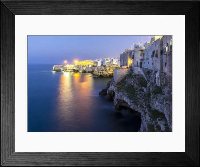 Framed Print : View of the overhanging houses and caves of Polignano a Mare at night. Bari district Framed Print : View of the overhanging houses and caves of Polignano a Mare at night. Bari district