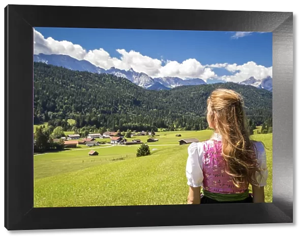 A girl in typical dress into the alpine landscape of GErold, Garmisch Partenkirchen Land
