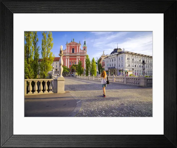 Framed Print : A girl walking in the old town of Ljubljana, with the Triple Bridge and the iconic
