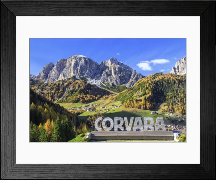 Framed Print : The colorful woods frame the village of Corvara and the high peaks at Badia Valley
