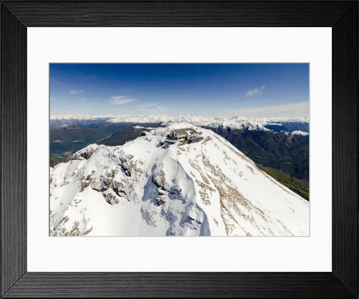 Framed Print : Aerial view of snowy peaks of Grignone with Brioschi Refuge on the summit Lecco Province