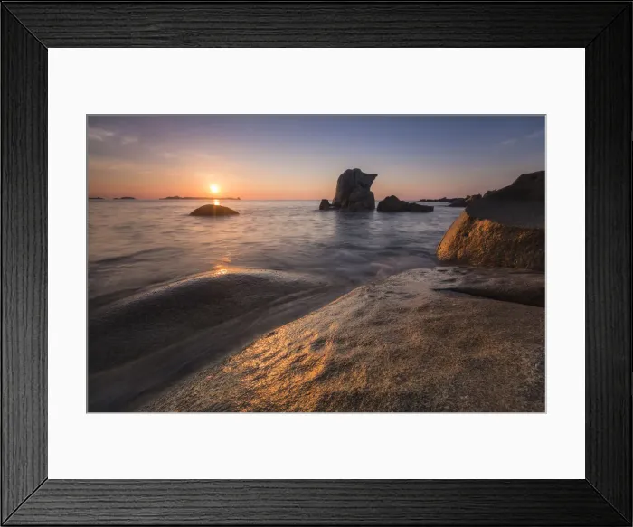 Framed Print : The golden lights of sunrise are reflected on the blue sea and cliffs Punta Molentis