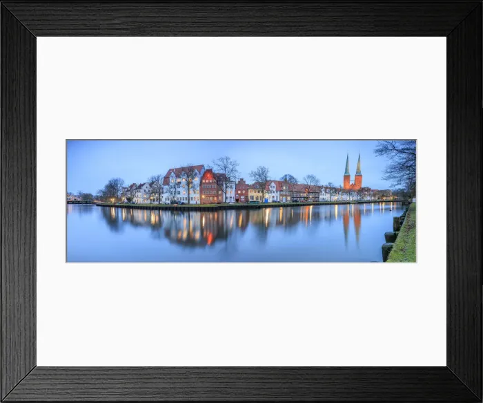 Framed Print : Panorama of typical houses and towers of cathedral reflected in river Trave at dusk Framed Print : Panorama of typical houses and towers of cathedral reflected in river Trave at dusk