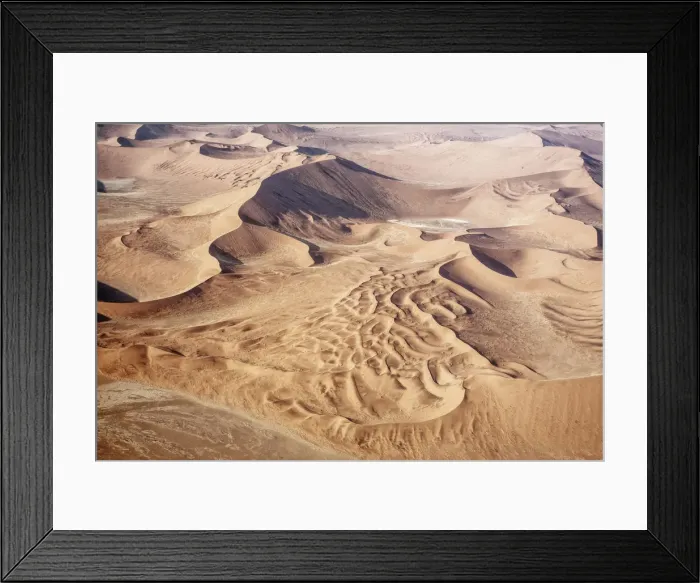 Framed Print : The Namib is an immense expanse of relentlessly moving gravel plains and dunes of