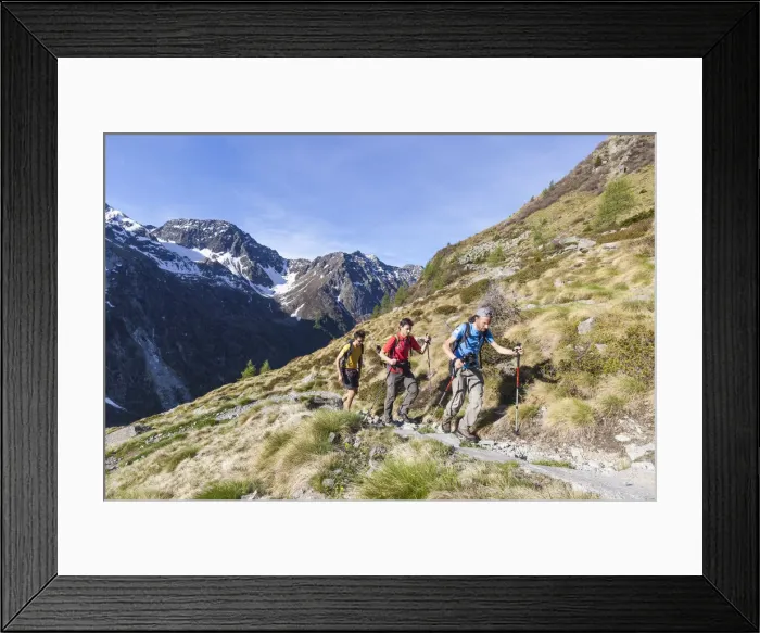 Framed Print : Hikers on the path with high peaks in the background Val Malga Adamello Regional Park Framed Print : Hikers on the path with high peaks in the background Val Malga Adamello Regional Park
