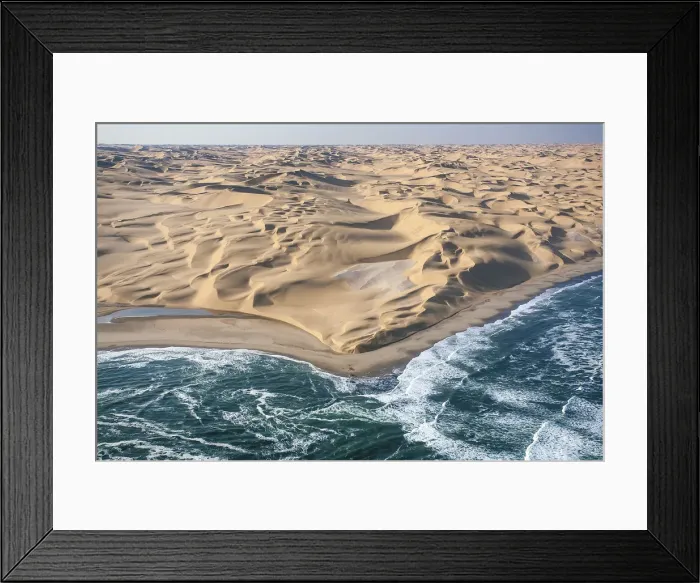 Framed Print : Aerial shot of the cold waters of the Atlantic Ocean meeting the sand dunes of