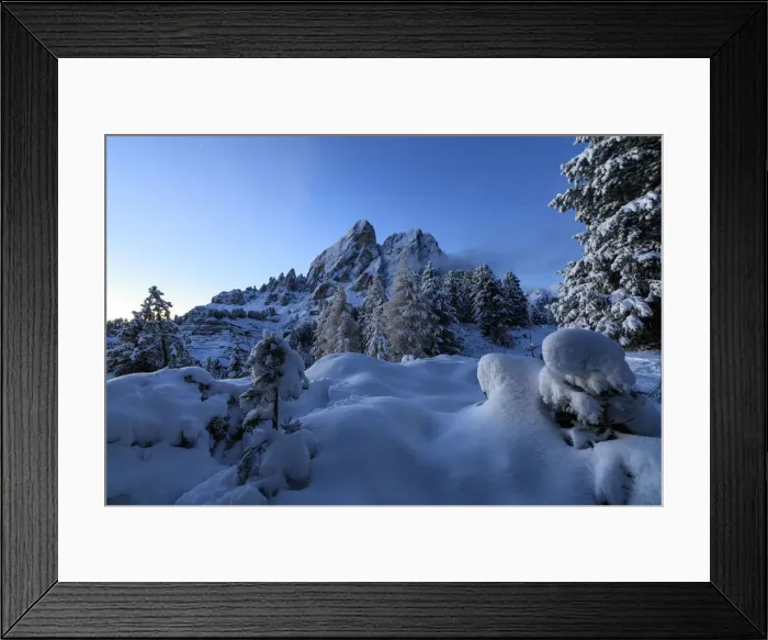 Framed Print : The high peak of Sass De Putia frames the snowy woods at dawn Passo Delle Erbe Funes