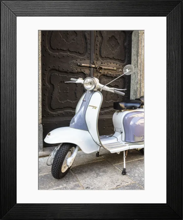 Framed Print : Bicolored Lambretta Innocenti scooter in front of ancient doorway, Morbegno, Sondrio