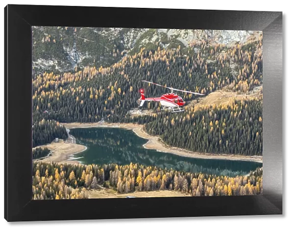 Aerial view of helicopter in flight on Lake Pal√πduring autumn